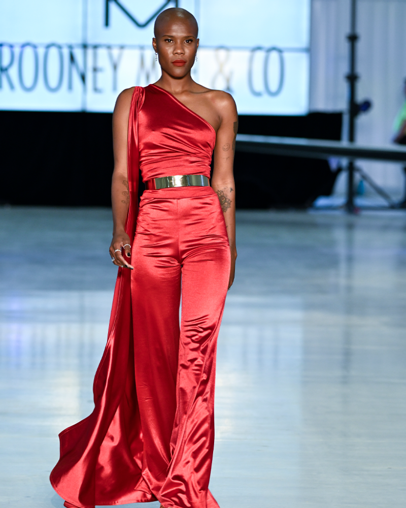 model walking the runway in a red satin jumpsuits-collection